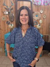 Load image into Gallery viewer, Woman standing wearing a indigo top, with leopard print
